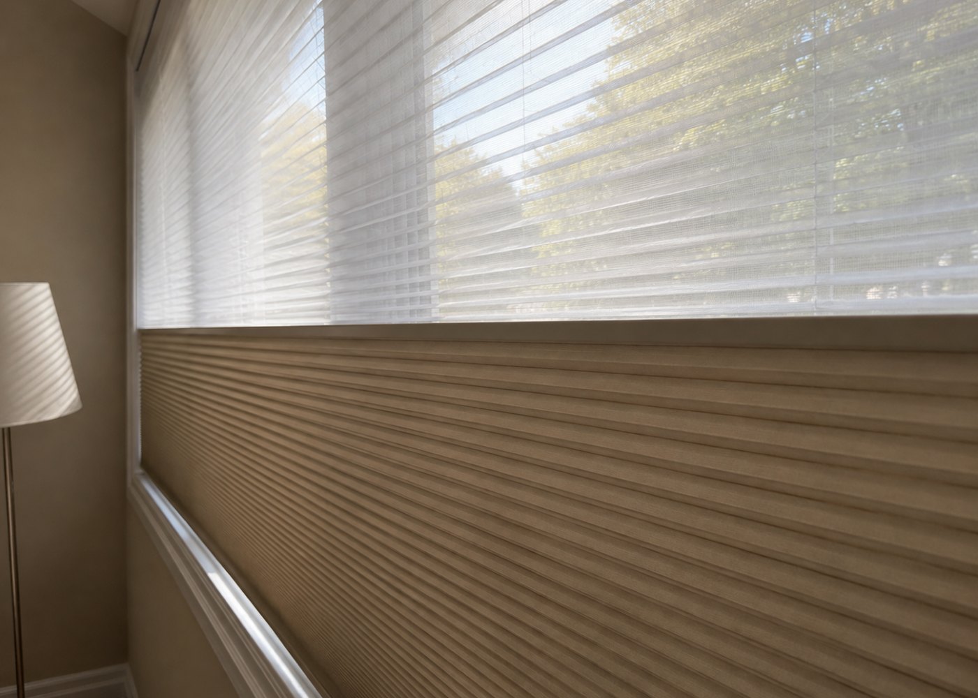 Close-up of a honeycomb blind: sheer pleats above, blackout cells below