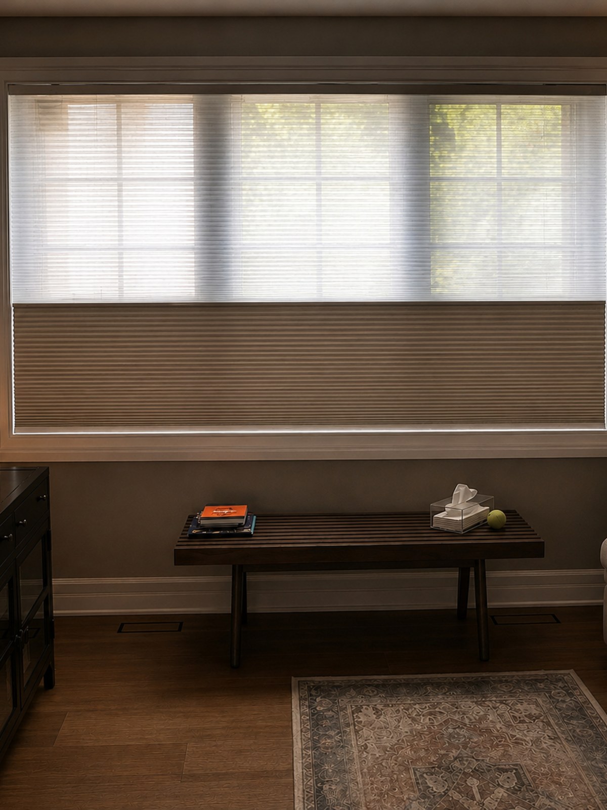 Honeycomb cellular blinds filtering warm daylight through a window